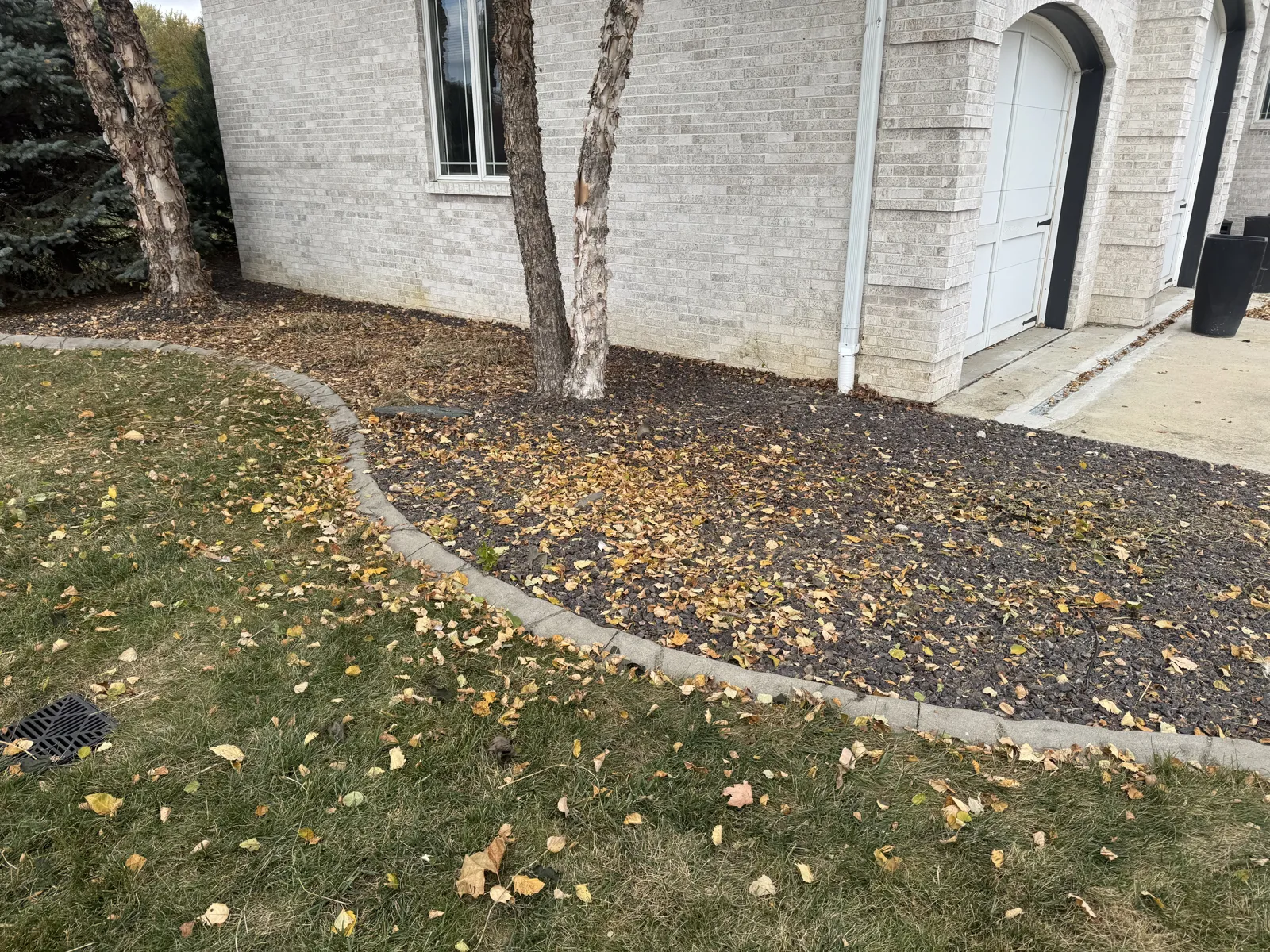 Same mulch bed and lawn with the branch pile removed
